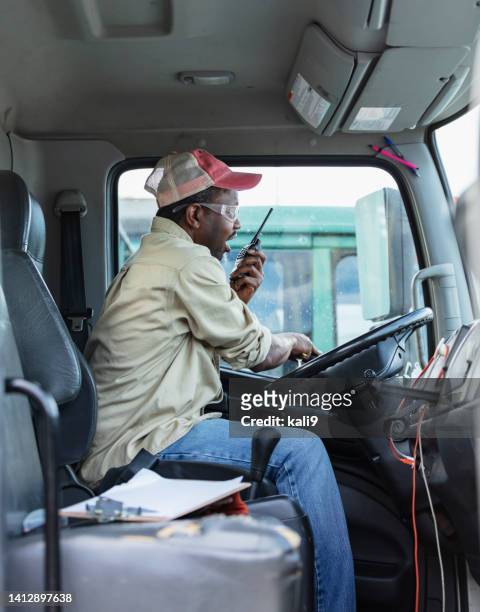 african-american truck driver on walkie-talkie - trucker hat stock pictures, royalty-free photos & images
