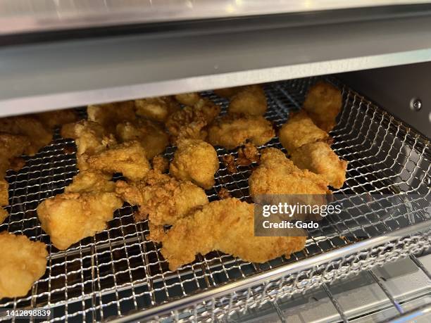 Chicken nuggets are visible in the basket of an air fryer in a domestic kitchen, Lafayette, California, July 18, 2022. Photo courtesy Sftm.