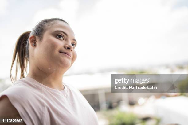 special needs young woman looking away contemplating outdoors - mental disability stock pictures, royalty-free photos & images