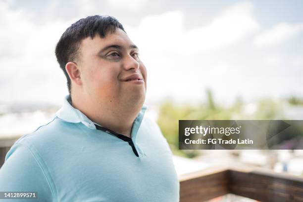 special needs mid adult man looking away contemplating outdoors - mental disability stock pictures, royalty-free photos & images