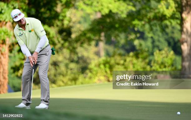 Charley Hoffman of the United States putts on the 14th green during the first round of the Wyndham Championship at Sedgefield Country Club on August...