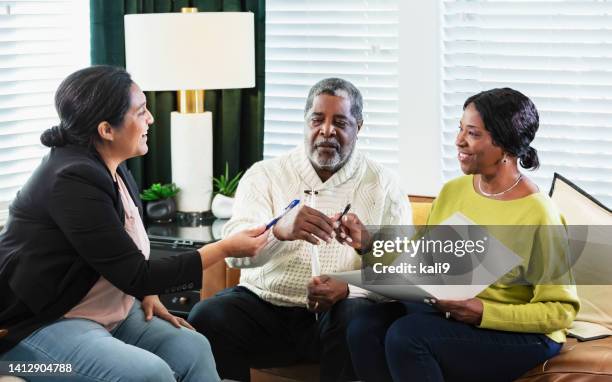 senior african-american couple with in home advisor - grant writer stock pictures, royalty-free photos & images