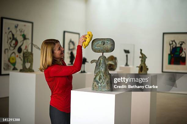 Clare Lilly, Director of program at Yorkshire Sculpture Park dusts Bronze sculpture, Femme by Joan Miro in the Yorkshire Sculpture park gallery on...