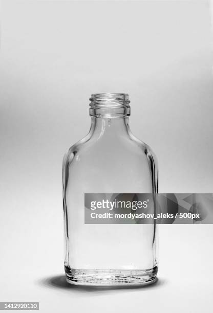 close-up of glass bottle against white background - ouzo stock pictures, royalty-free photos & images