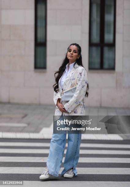 Tara Tut, aka tamtambeauty, wearing white and grey Dior sneaker, Fendi First grey leather bag, blue nakd jeans, Kragnart white blouse, a beige floral...