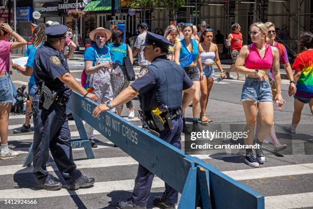 police officers and a barricade on the street - barricade stock pictures, royalty-free photos & images