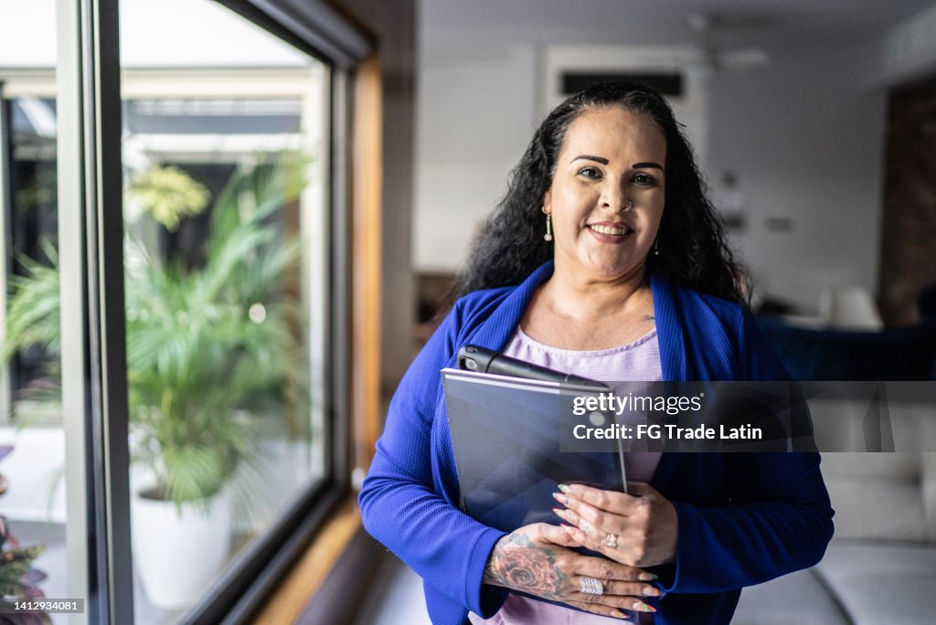 Portrait of real estate agent in the living room at home