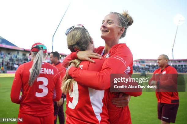 Danni Wyatt and Sophie Ecclestone of Team England celebrate following victory in the Cricket T20 Group B match between Team England and Team New...