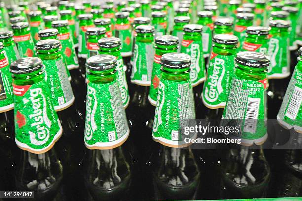 Bottles of lager move along a conveyor belt at the Carlsberg A/S production plant in Kiev, Ukraine, on Wednesday, March 14, 2012. Sales in the...