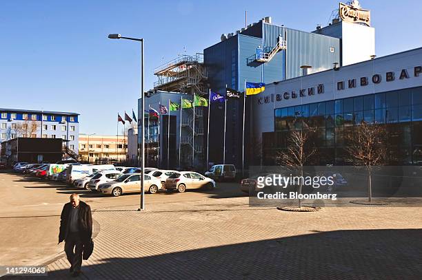 An employee leaves work at the Carlsberg A/S production plant in Kiev, Ukraine, on Wednesday, March 14, 2012. Sales in the Ukraine were...
