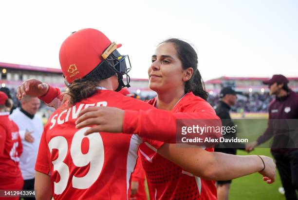 Maia Bouchier of Team England celebrates with teammate Nat Sciver following victory in the Cricket T20 Group B match between Team England and Team...