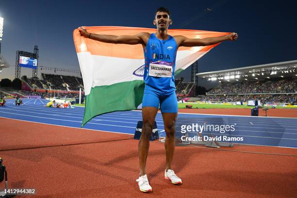 Silver medalist Sreeshankar Sreeshankar of Team India celebrates with their countries flag following the Men's Long Jump Final on day seven of the...