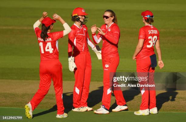 Sophie Ecclestone of Team England celebrates taking a wicket with teammates during the Cricket T20 Group B match between Team England and Team New...