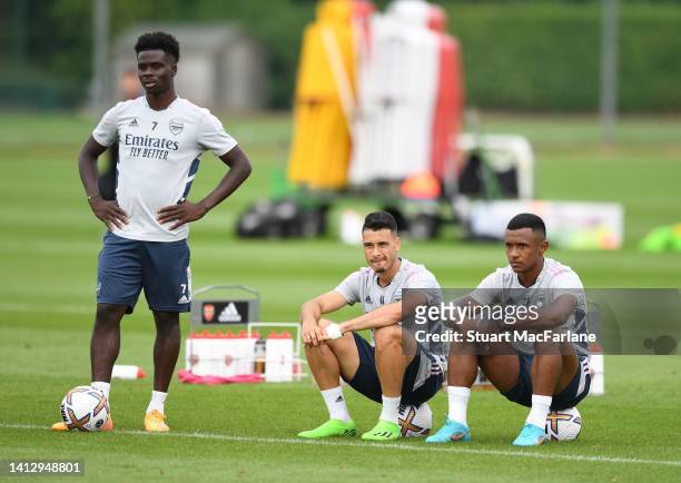 Bukayo Saka, Gabriel Martinelli and Marquinhos of Arsenal during a training session at London Colney on August 04, 2022 in St Albans, England.
