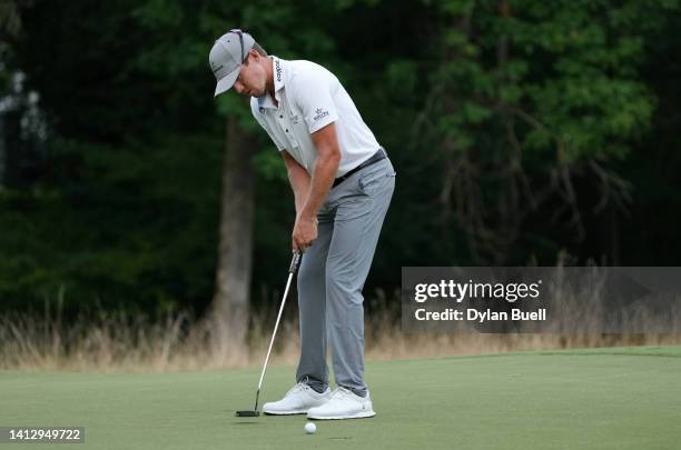 Kramer Hickok of the United States putts on the first green during the first round of the Wyndham Championship at Sedgefield Country Club on August...