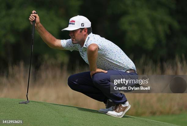 Robert Streb of the United States lines up a putt on the first green during the first round of the Wyndham Championship at Sedgefield Country Club on...