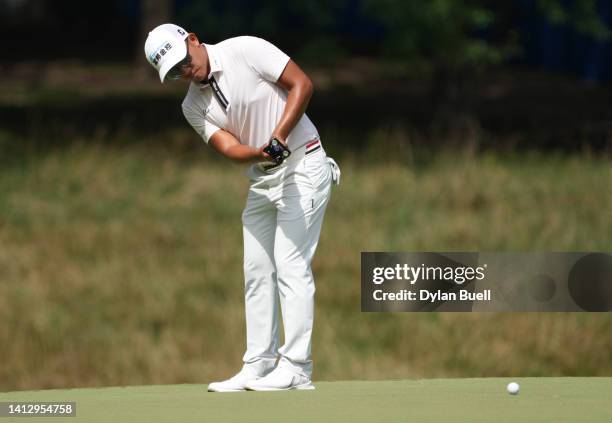 Pan of Taiwan putts on the first green during the first round of the Wyndham Championship at Sedgefield Country Club on August 04, 2022 in...