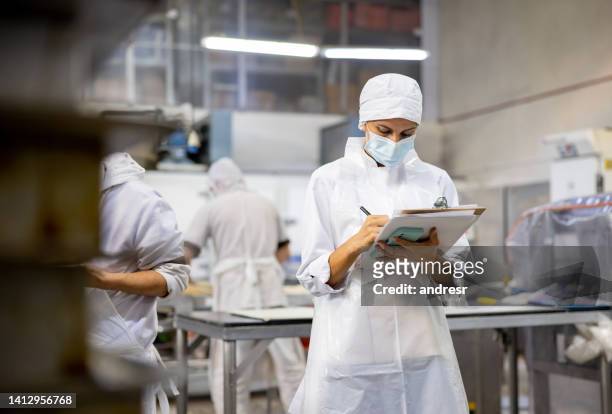 woman working at an industrial bakery and doing quality control - food and drink production stock pictures, royalty-free photos & images