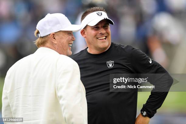 Head coach Josh McDaniels of the Las Vegas Raiders talks with Raiders owner Mark Davis prior to the 2022 Pro Hall of Fame Game against the...