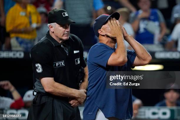 Manager Alex Cora of the Boston Red Sox reacts after being ejected from a game against the Kansas City Royals by plate umpire Bill Welke in the...