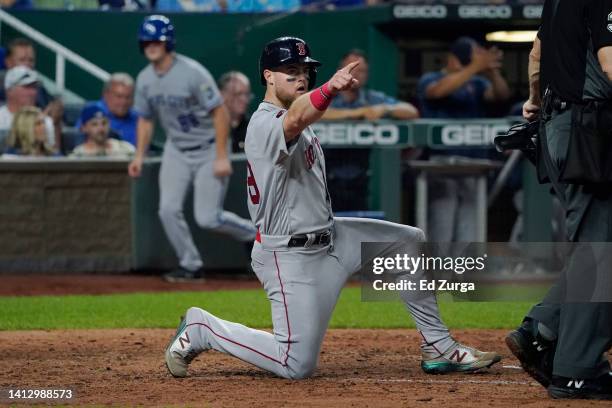 Christian Arroyo of the Boston Red Sox celebrates after scoring on a Kevin Plawecki single in the seventh inning against the Kansas City Royals at...