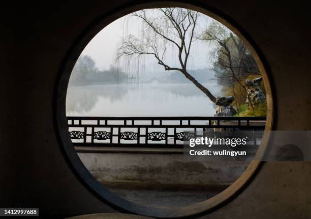 view from a chinese classic circle gate - formal garden gate stock pictures, royalty-free photos & images