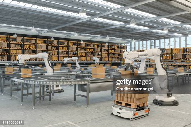 distribution warehouse with automated guided vehicles and robots working on conveyor belt - robotics stockfoto's en -beelden