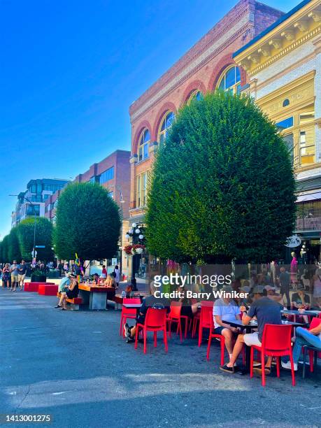 people dining outdoors on street, victoria - victoria canada dining stock pictures, royalty-free photos & images