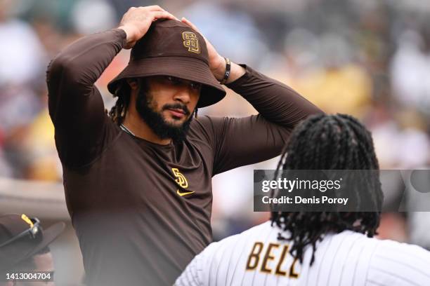 Fernando Tatis Jr. #23 of the San Diego Padres talks with Josh Bell during a baseball game against the Colorado Rockies August 4, 2022 at Petco Park...