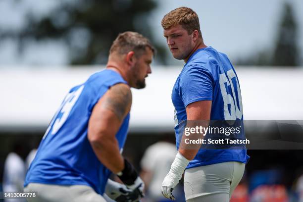 Logan Bruss of the Los Angeles Rams participates in a drill with Rob Havenstein during training camp at University of California Irvine on July 29,...