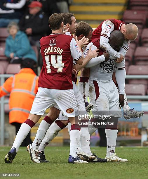 Adebayo Akinfenwa of Northampton Town is congratulated by team mates after scoring his first and his teams second goal during the npower League Two...