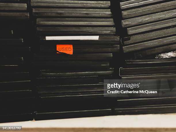 stacks of old dvd cases stored on shelf in closet - dvd photos et images de collection