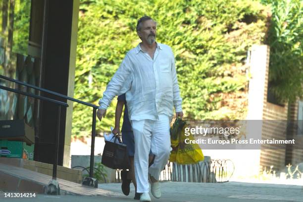 Miguel Bose leaves a fruit shop with one of his sons on July 27 in Madrid, Spain.