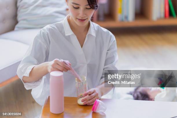 mother making milk for her baby - powdered milk stock pictures, royalty-free photos & images