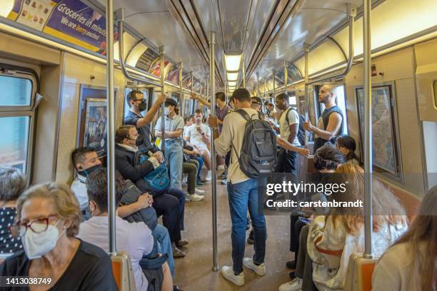 people with face masks in a subway train - crowd masks stock pictures, royalty-free photos & images