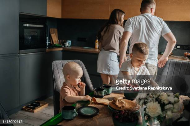 family dinner proper nutrition pancakes and strawberries - making dinner stock pictures, royalty-free photos & images