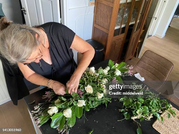 making a mourning bouquet - mourning stock pictures, royalty-free photos & images