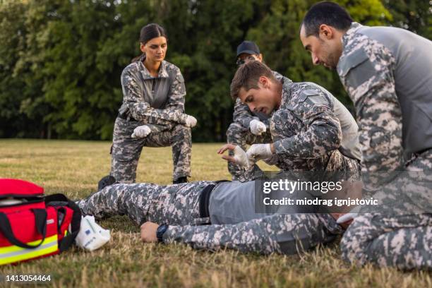 military team having an first aid training course - special forces stock pictures, royalty-free photos & images