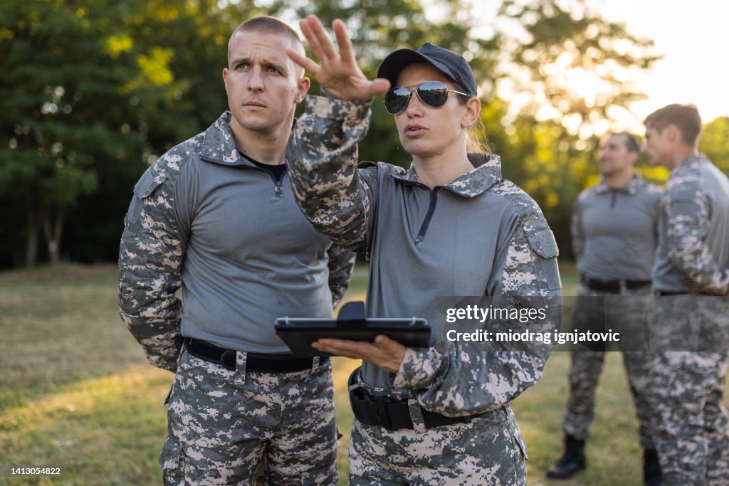 Female and male sargeant organizing the military training while using digital tablet