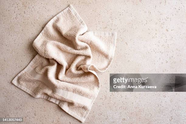 close-up of folded bath towel on concrete background, top view - bath towels stock-fotos und bilder