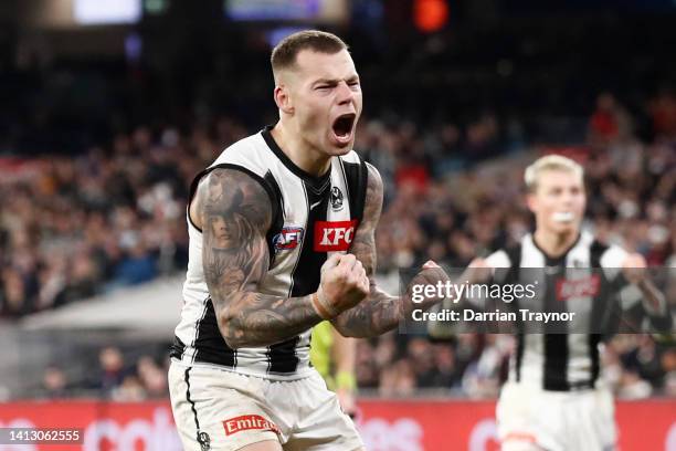 Jamie Elliott of the Magpies celebrates a goal during the round 21 AFL match between the Melbourne Demons and the Collingwood Magpies at Melbourne...