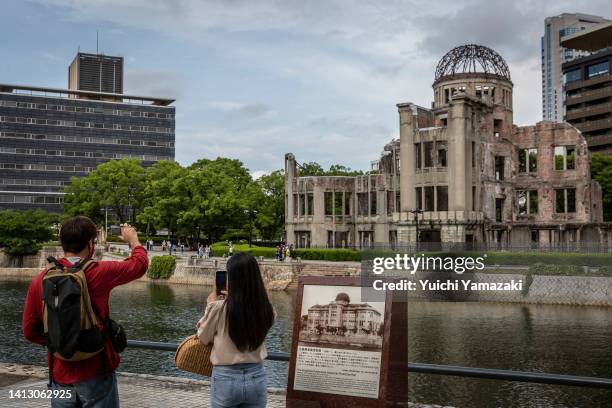 People take photographs of the Atomic Bomb Dome on August 05, 2022 in Hiroshima, Japan. This Saturday will mark the 77th anniversary of the atomic...