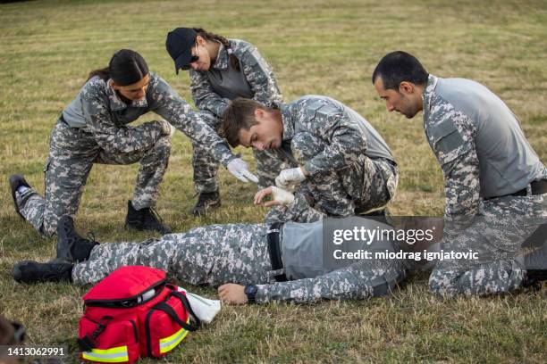 military team having an first aid training course - army training stock pictures, royalty-free photos & images
