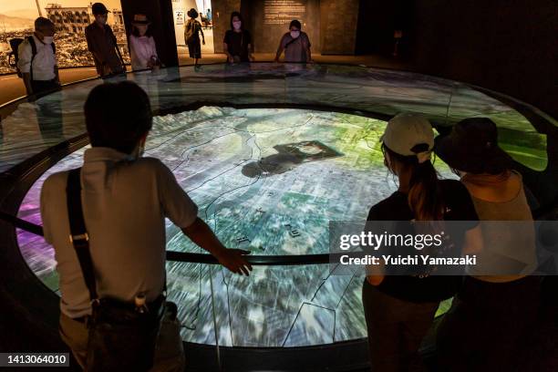 Visitors at Hiroshima Peace Memorial Museum view a screen showing the atomic bomb attack on Hiroshima, on August 05, 2022 in Hiroshima, Japan. This...