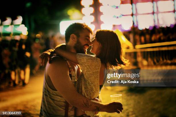 love at a music festival. - kissing mouth stock pictures, royalty-free photos & images