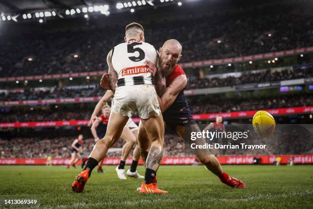 Max Gawn of the Demons bumps Jamie Elliott of the Magpies during the round 21 AFL match between the Melbourne Demons and the Collingwood Magpies at...