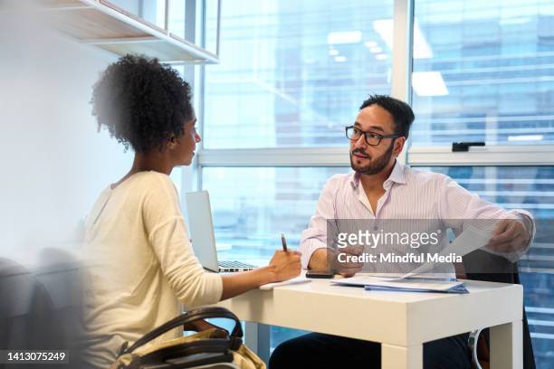 adult male financial advisor discussing with female customer at office - bankruptcy stock pictures, royalty-free photos & images
