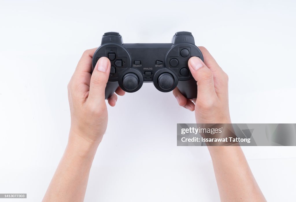 Hand holding game controller isolated on white background