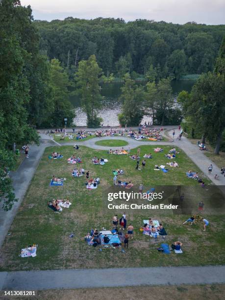 In this aerial view, people attend at Schlachtensee lake in the evening on August 04, 2022 in Berlin, Germany. Temperatures are expected to reach 38...