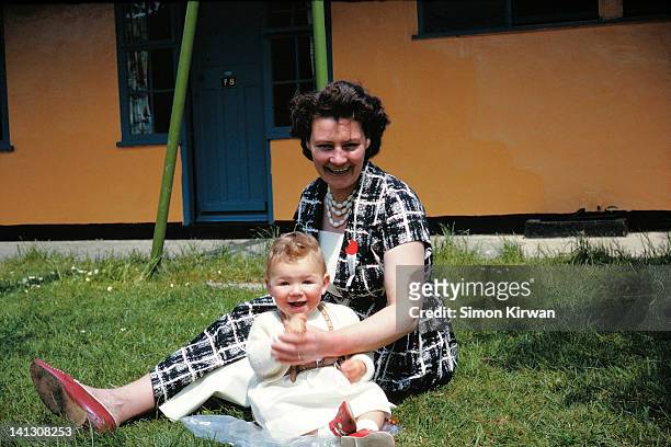 mother and child sitting on grass - archival stock pictures, royalty-free photos & images